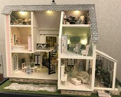 a doll house with all the furniture and accessories in it's display case is shown