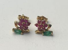 Vintage Ruby and Emerald flower shape 9ct Yellow Gold Stud Earrings perfect as birthday gift, anniversary gift and more. You choose the occasion, we have the gift. Hallmarked 9k on the posts. Dispatched with Royal Mail Special Delivery. Earrings Total Weight:1.40g Earrings Length:14.5mm Ruby Weight:approx. 0.35ct (each earring) Emerald Weight:approx.0.08ct (each earring) Things to know before you buy. *When purchasing our products from outside the UK they may be subject to import tax. Please check customs duties rules on your governments website.  *Almost all of our products are vintage or antique therefore, it may be possible for the items to have wear, if you would like a video of the item let us know your email address and we will send one to you :)  *Lastly, we have the best jewllery o Flower-shaped Hallmarked Earrings For Anniversary, Flower Shaped Hallmarked Earrings For Anniversary, Yellow Gold Stud Earrings, Safety Pin Earrings, Gold Topaz, Stacked Earrings, Gold Ring Sets, Gold Stud Earrings, Mystic Topaz