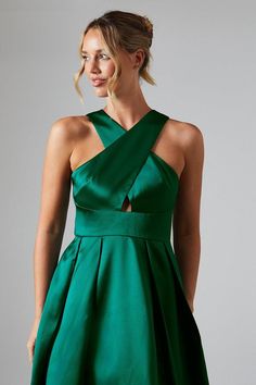 a woman in a green dress posing for the camera