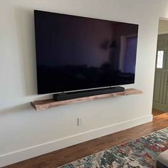 a flat screen tv mounted on the wall in a living room