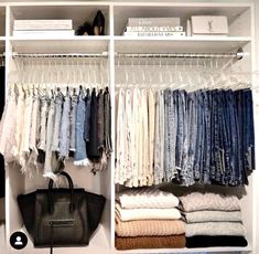 an organized closet with clothes and handbags