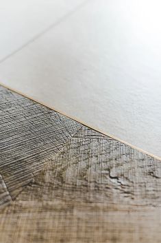 a close up view of a wood floor with white paint on the top and bottom