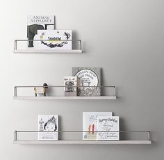 two white shelves with books and magazines on them