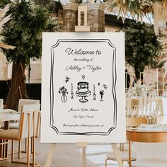 a welcome sign in front of a table with chairs and tables set up for an event