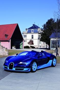 a blue and black bugatti parked in front of a house