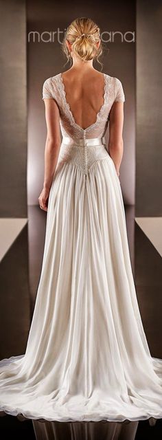 the back of a woman's wedding dress in front of a black and white background