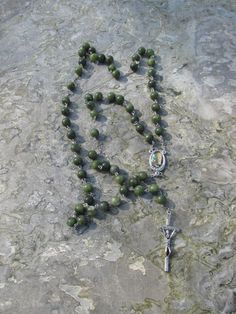 This is a hand carved and hand polished set of Connemara green marble rosary beads. They are made from 8mm Connemara beads which are of the highest quality, it has an our lady of Lourdes colour image centre piece and Papal crucifix. Will come in presentation case as shown. Handmade Green Rosary, Green Rosary With 8mm Beads, Green 8mm Beads Spiritual Rosary, Connemara Marble, Lady Of Lourdes, Our Lady Of Lourdes, Centre Piece, Rosary Beads, Green Marble