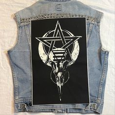 a denim jacket with a pentagramil on the back