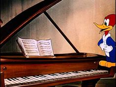 donald duck playing the piano with sheet music