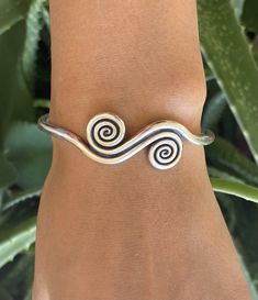 ❋ Sterling Silver Adjustable Rounded Engraved Bangle Bracelet With Spirals and Ethnic Symbolic Engraving Design ❋ Size: Adjustable, Medium -Large for women, Small- Medium for men ❋ The Length (end to end) is 6 7/8 - 17.5cm ❋ Wight: 0.65 ounces (about 18 grams) ❋ Metal Purity: 98% Pure Silver (Purer than sterling Silver - 92.5%) To browse some more of our Silver Jewelry collection you can click on the following links: https://www.etsy.com/shop/SilverShapes Earrings: https://www.etsy.com/shop/Silv Adjustable Bohemian Sterling Silver Bracelet, Handmade Adjustable Spiral Cuff Bracelet, Adjustable Bohemian Sterling Silver Bangle Bracelet, Adjustable Symbolic Spiral Jewelry, Symbolic Adjustable Spiral Jewelry, Symbolic Bangle Bracelet For Festivals, Traditional Adjustable Spiral Jewelry, Handmade Bohemian Spiral Bracelets, Handmade Spiral Bohemian Bracelets