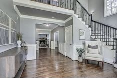 a living room filled with furniture and a stair case