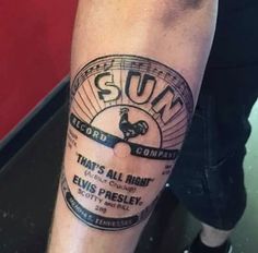 a man with a tattoo on his leg that reads sun records, that's all right elvis presley