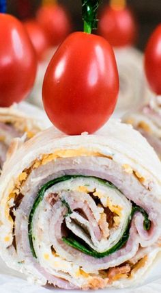 a close up of a sandwich on a plate with tomatoes