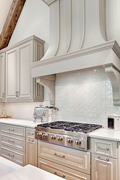 a stove top oven sitting inside of a kitchen next to white counter tops and cabinets