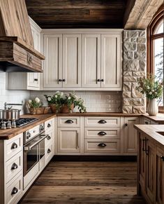 a kitchen with wooden floors and white cabinets, wood flooring, and stone walls