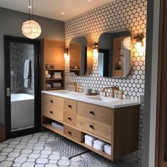 a bathroom with two sinks and mirrors in it