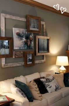 a living room filled with furniture and framed pictures on the wall above it's couch