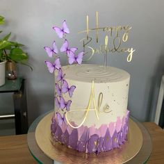 a birthday cake with purple butterflies on top