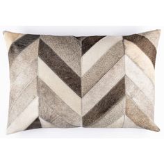 three pillows with different colors and patterns on the front, one is brown and white