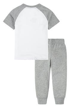 Give your kid sporty style with this logo printed T-shirt and joggers set constructed from a soft cotton blend. Set includes T-shirt and joggers 60% cotton, 40% polyester Machine wash, tumble dry Imported Nike Sporty T-shirt For Loungewear, Nike Cotton T-shirt For Loungewear, Cotton Sport Sets With Graphic Print, Cotton Graphic Print Sports Sets, White Sporty Sets With Relaxed Fit, Sporty White Relaxed Fit Set, White Relaxed Fit Sporty Sets, Nike Sporty Short Sleeve Sets, Cotton Sporty Joggers With Logo Print