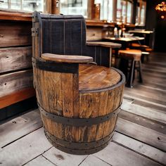 a wooden barrel sitting on top of a hard wood floor next to tables and chairs