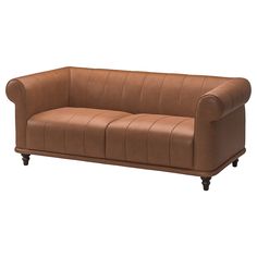 a brown leather couch sitting on top of a white floor