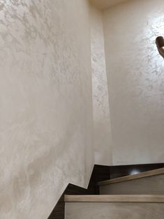 a stair case in a house with white walls