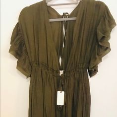 Feminine And Flowy Maxi Dress. New With Tags! Feel Earthy In This “Olive” Hue. Dress Ties Beneath The Bust And Is Accentuated With Small Buttons Up The Center Dress Line. Open “V” Neck Casually Dips In Front And Back, Flattering The Skin. Sweet Flutter Sleeves Give A Renaissance Feeling. Perfect For Baby Bumps But Beautiful And Versatile For All Body Types. This Dress Is Lovely For Summer Or Fall! Wear With A Denim Jacket Or Corduroy Blazer And Boots On Cooler Days Or Nights. “Anika Flutter Sleeve Dress” Green Flutter Sleeve Beach Midi Dress, Chic Green Rayon Mini Dress, Chic Green Mini Dress With Flutter Sleeves, Chic Flutter Sleeve Dresses In Rayon, Chic Rayon Dress With Flutter Sleeves, Chic Olive Maxi Length Dress, Olive Summer Dress For Daywear, Olive Dress For Summer Daywear, Elegant Olive Maxi Dress For Summer