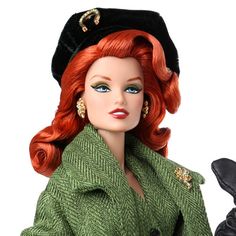 a doll with red hair wearing a green coat and black hat