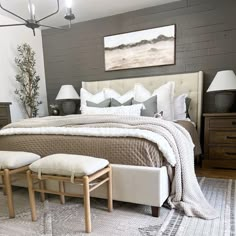 a bedroom with a large bed and two stools