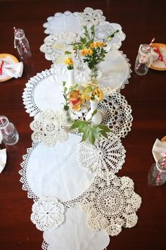 the table is covered with doily and flowers