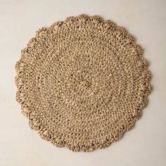 a round placemat made out of jute on a white surface