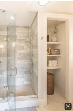 a walk in shower sitting next to a white sink