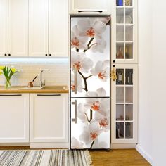 a refrigerator with flowers painted on it in a kitchen