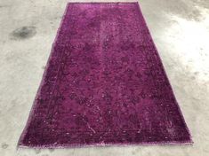 a purple rug is laying on the floor