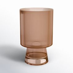 a brown glass vase sitting on top of a table