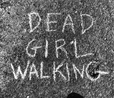 the words dead girl walking are written in white chalk on a black and white background