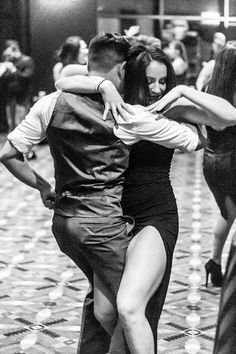 two people are dancing on the dance floor