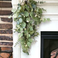 a green plant hanging from the side of a fireplace