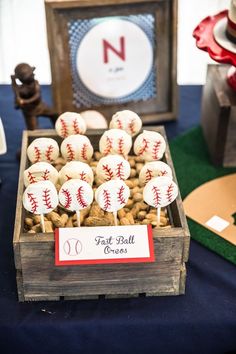 a wooden box filled with baseball cake pops