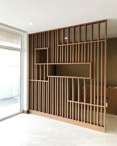 an empty room with wooden shelves on the wall and sliding glass doors to the outside