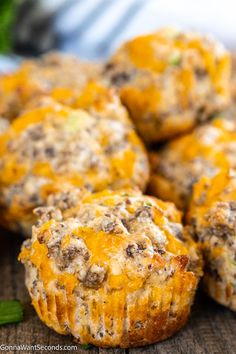 several cheesy muffins on a wooden surface