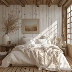 a bedroom with wooden walls and white bedding on the floor, along with an open window