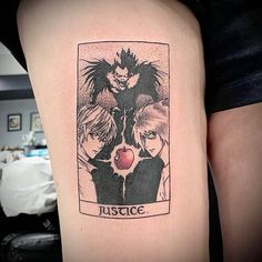 a woman with a tattoo on her thigh that has an image of two anime characters