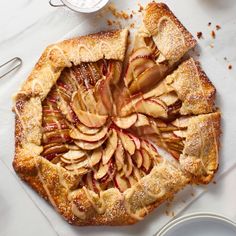 an apple pie is cut into slices on a cutting board