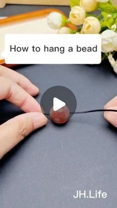 two hands holding a string with the words how to hang a bea