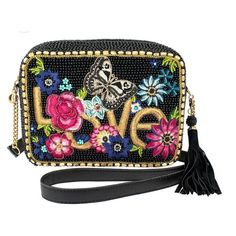 8 X 2.5 X 6" Strap Length End To End: 49" Strap Drop: 22" The Mary Frances Love Is Love Beaded Crossbody Clutch Handbag In Multi Celebrates Love With A Captivating Design That Features Metallic Gold Embroidery On A Striking Black Background. Surrounding The "Love" Text Is A Bold Embroidered Butterfly And Vibrant Flowers, Embellished With Intricate Beaded Accents, Adding A Touch Of Whimsy And Charm To The Design. The Handbag Comes With A Removable Leather And Chain Crossbody Strap, Providing Vers Womens Workout Shoes, Beaded Crossbody Bag, France Love, Handbag Boutique, Butterfly Bags, Embroidered Butterfly, Vibrant Flowers