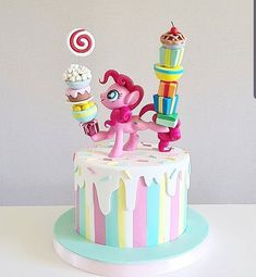 there is a cake decorated with an image of a pink pony on top of it