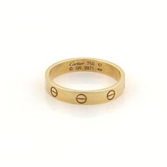 This is an authentic band ring by Cartier, this beautiful authentic designer ring is crafted from 18k yellow gold with a fine polished finish and comes from Cartier's famous LOVE collection in the mini style. It is a piece of absolute style and substance and has full designer hallmark and metal content with serial number.  Material:  18k yellow gold.     Hallmark:  Cartier 750 61 GR9971 Measurements: Band is: 3.5mm wide  Ring Size:  US: 9.75  European: 61 Weight: 4.7 grams Stock#: 51154 Mini Love, Wide Ring, Wide Rings, Mini Fashion, Band Ring, Cartier, Ring Designs, Hallmark, Band Rings