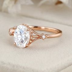 a rose gold engagement ring with an oval cut diamond